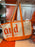 DLR/WDW - Logo Mania 2026 Park Hopper - Bright Orange Park Logo Canvas Tote Bag