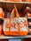 DLR/WDW - Logo Mania 2026 Park Hopper - Bright Orange Park Logo Canvas Tote Bag